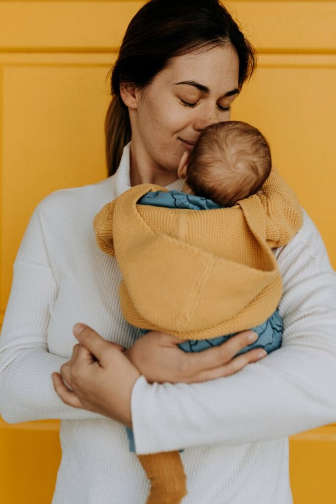 A tender moment between a mother and her baby, highlighting warmth and love.